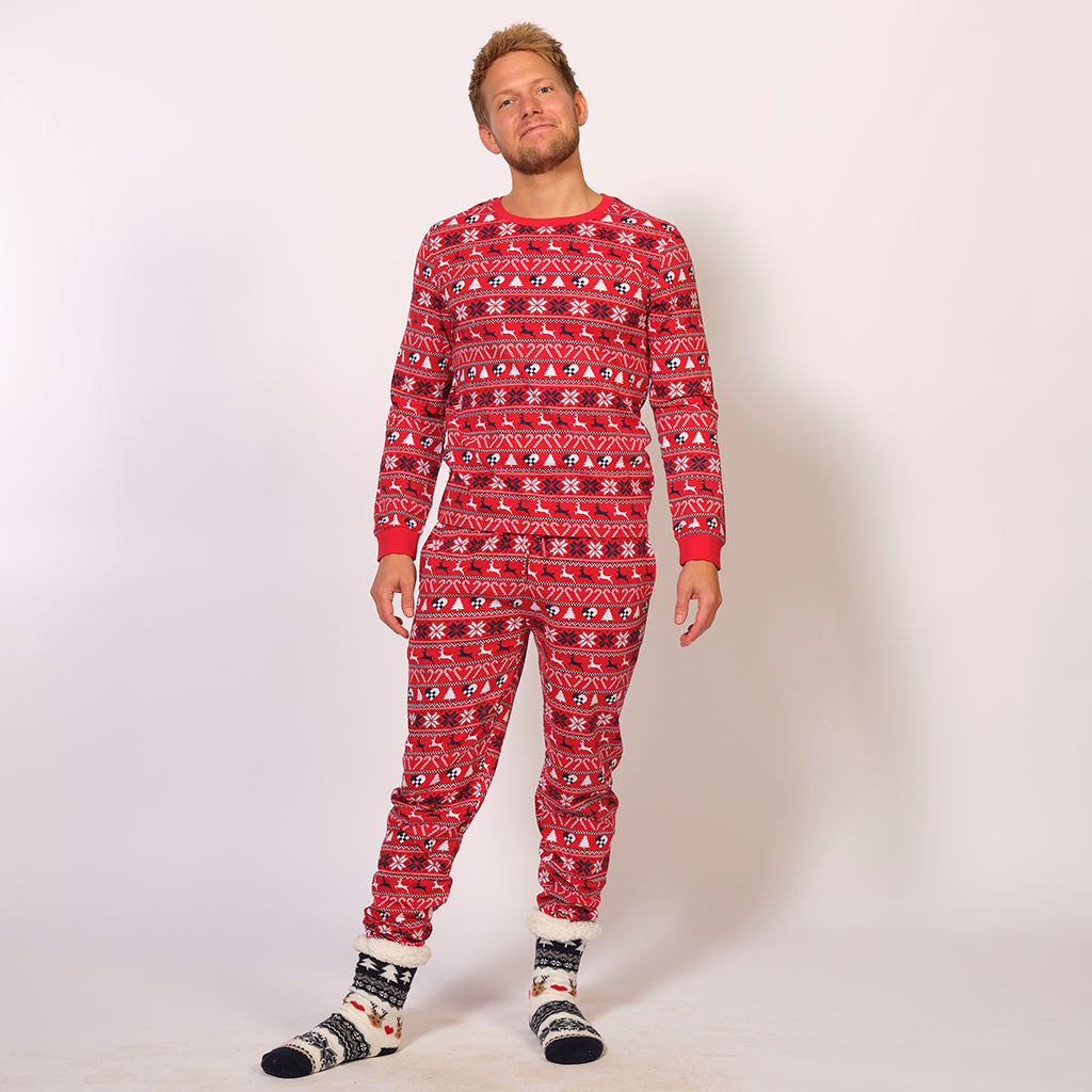 En mand iført et par røde julepyjamas.