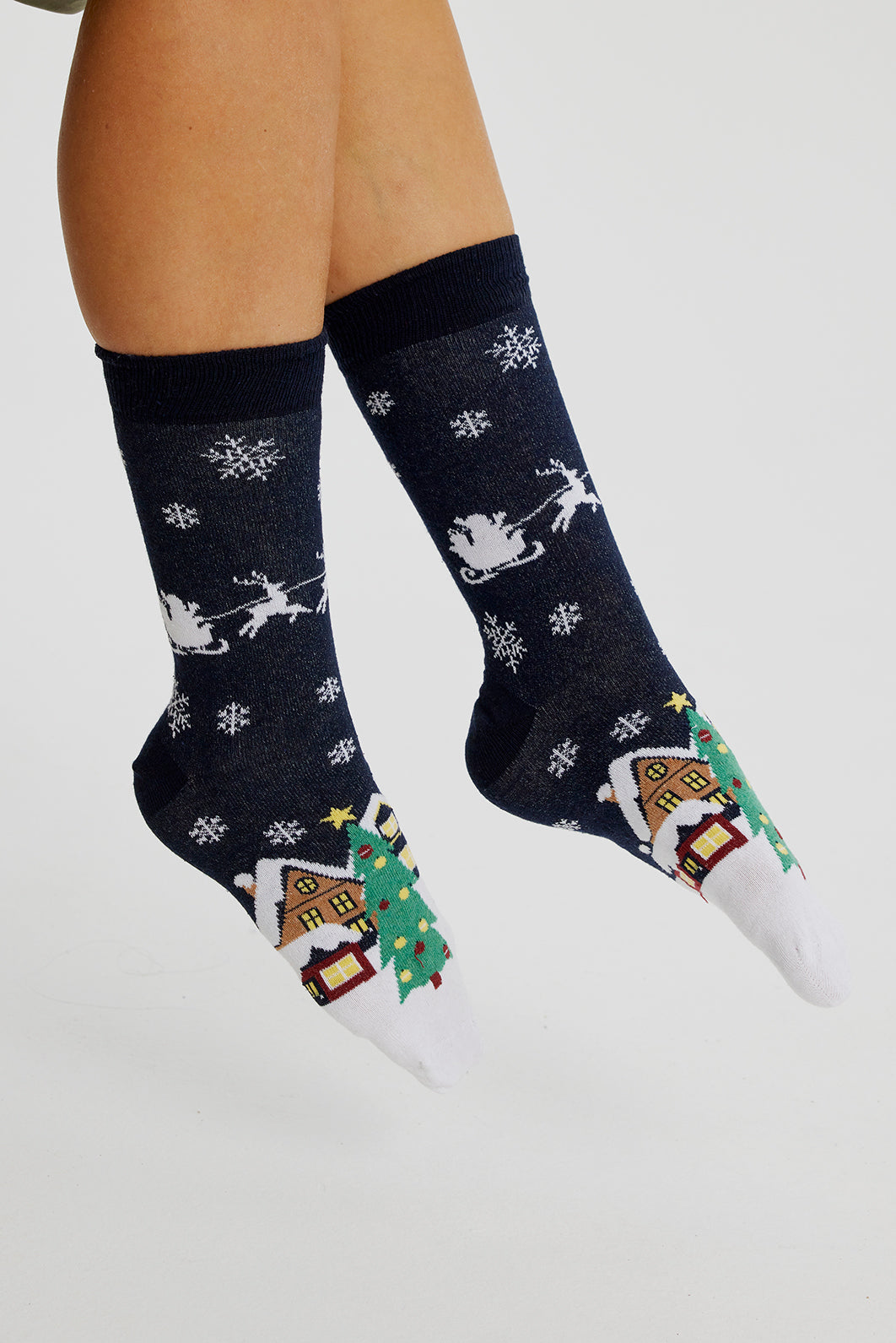 Et par fødder iklædt sorte julesokker.