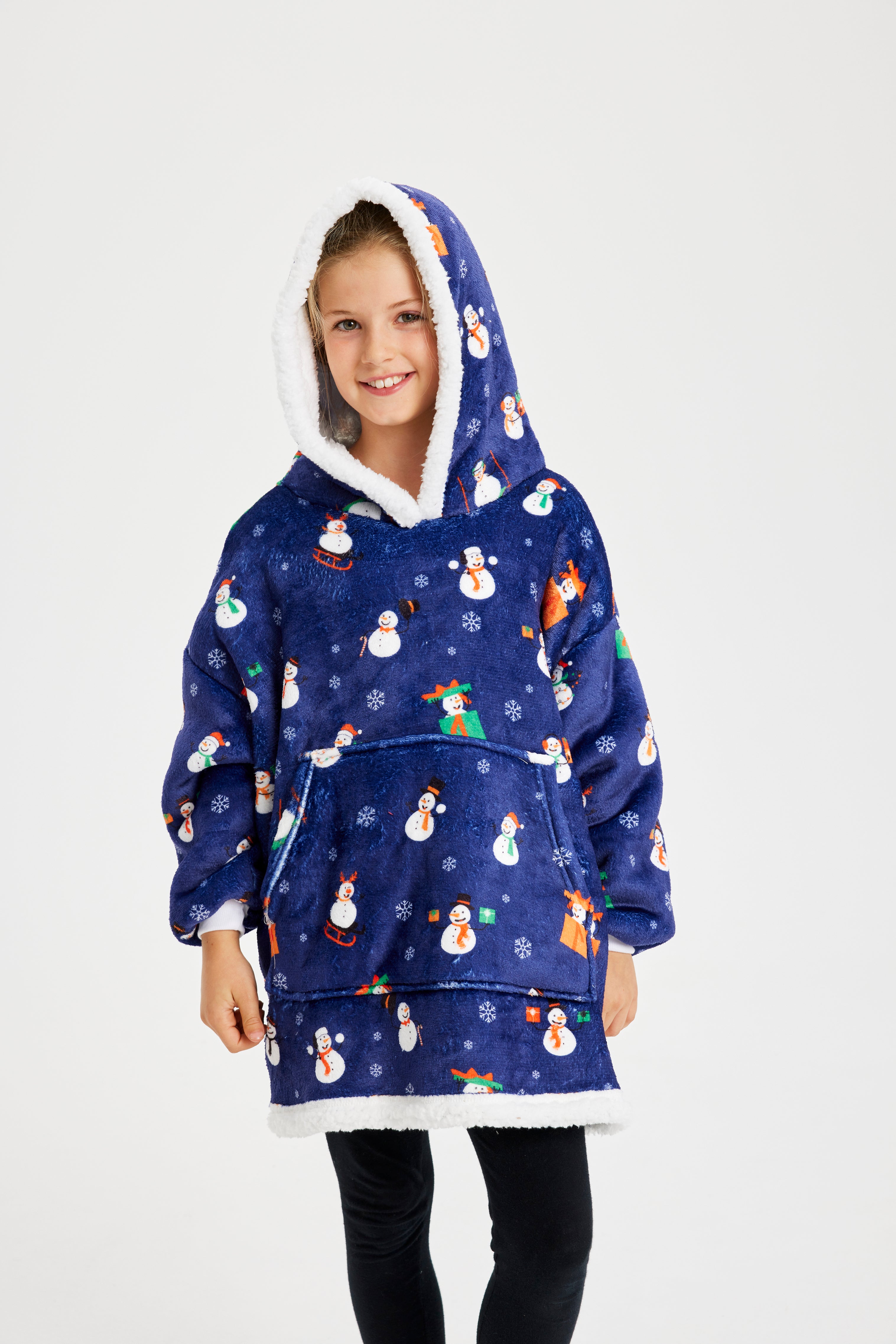Et smilende barn iført en blå julehoodie med snemænd.